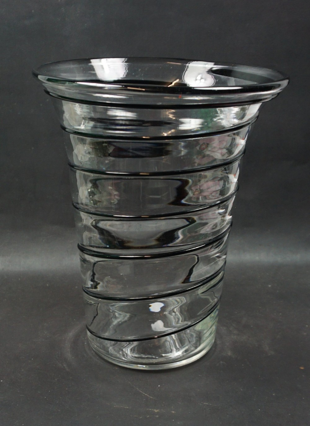 A clear crystal flared vase featuring a continuous spiral of applied black glass cane decoration around its exterior.