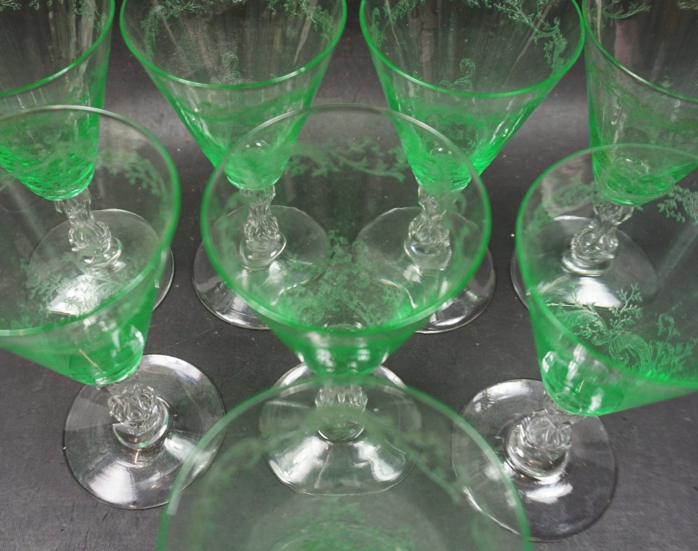 A set of eight French St. Louis green uranium glass wine goblets with etched Mikado patterns and clear stems. View II