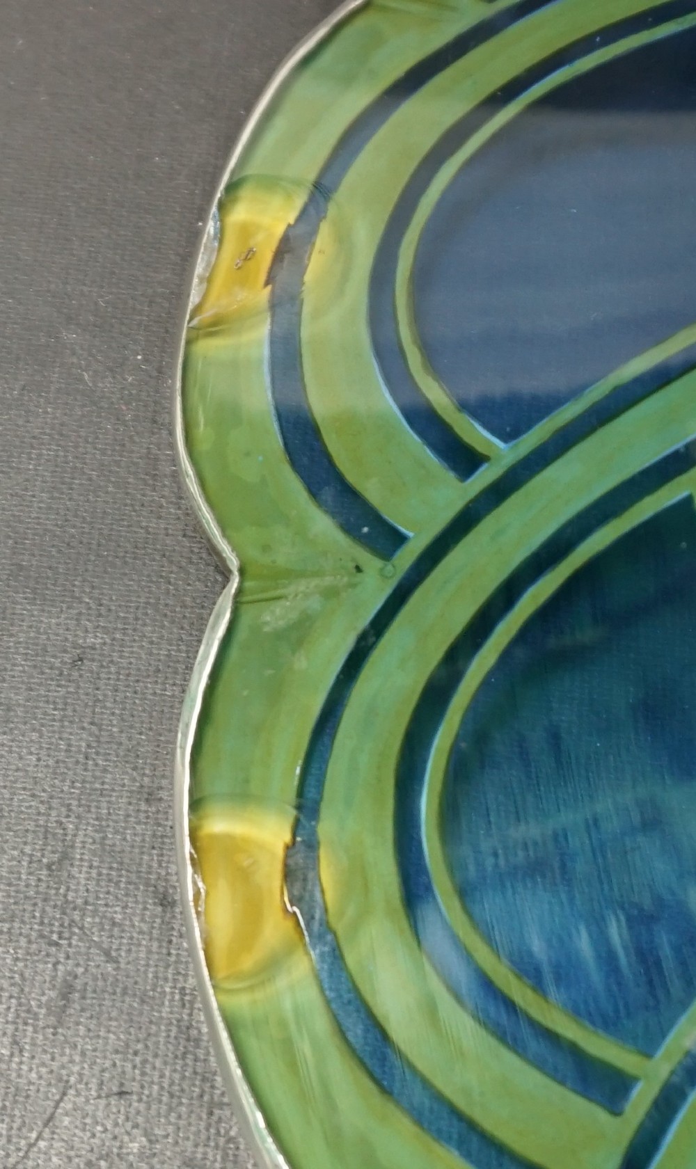A cobalt blue cut crystal bowl featuring a flared scalloped rim decorated with geometric silver overlay arches and circular lens cuts around the lower body. View IV