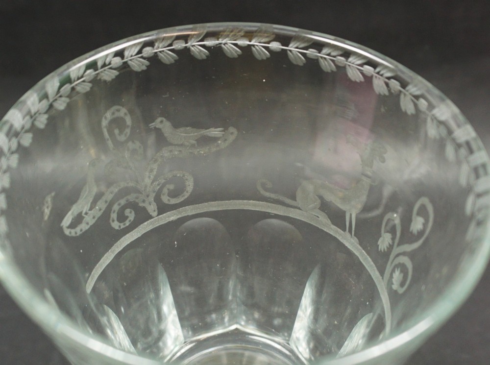 A clear glass marriage goblet featuring wheel-engraved foliage, a dated crest from 1847, a faceted lower bowl, and an octagonal cut foot. View II