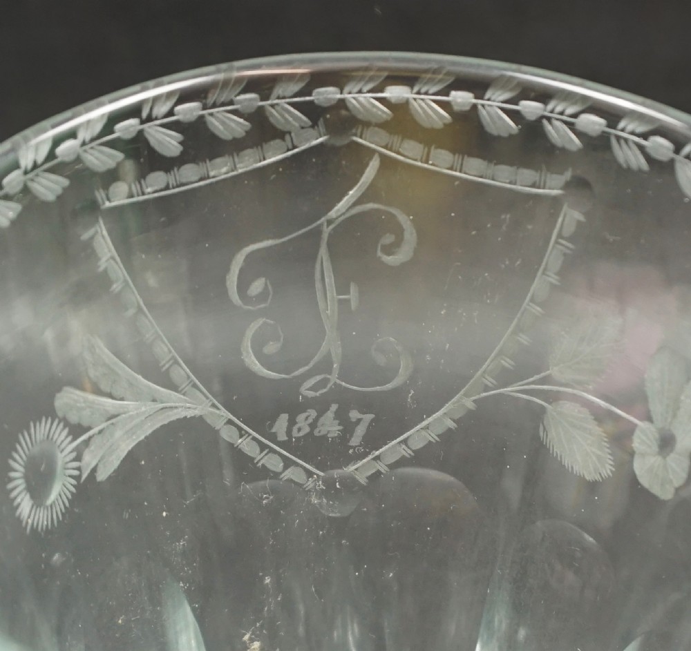 A clear glass marriage goblet featuring wheel-engraved foliage, a dated crest from 1847, a faceted lower bowl, and an octagonal cut foot. View III