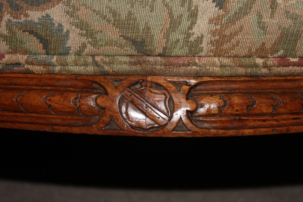 A Victorian carved walnut settee featuring button-tufted floral tapestry upholstery and scrolled wooden legs. View VI