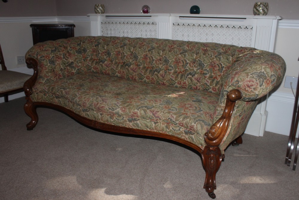 A Victorian carved walnut settee featuring button-tufted floral tapestry upholstery and scrolled wooden legs. View XI