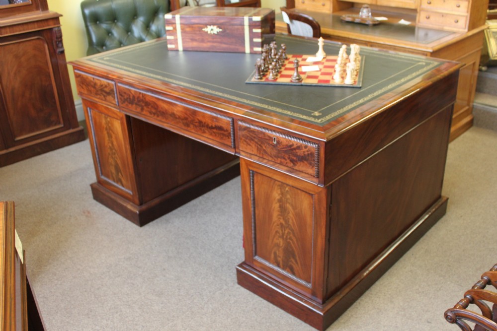 A fine 19th. century Regency period mahogany pedestal partners desk.
