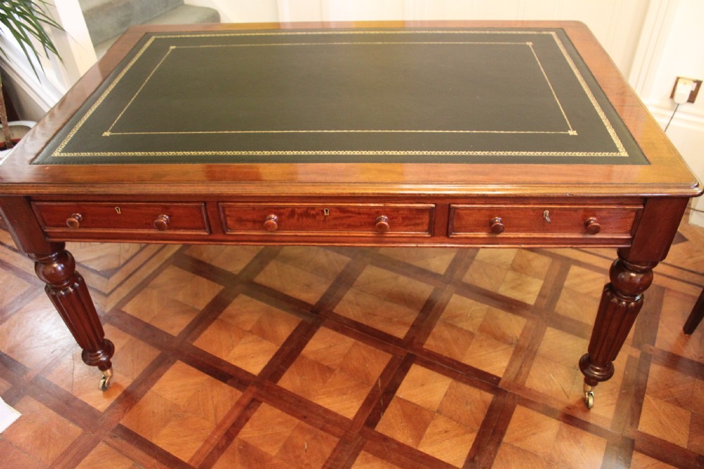 An early 19th century light mahogany six drawer partners library table View II