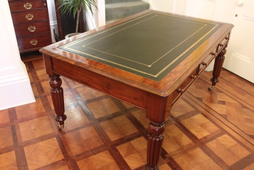 An early 19th century light mahogany six drawer partners library table View VI