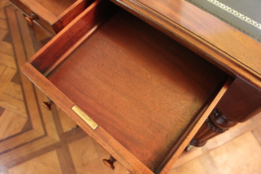 An early 19th century light mahogany six drawer partners library table View IX