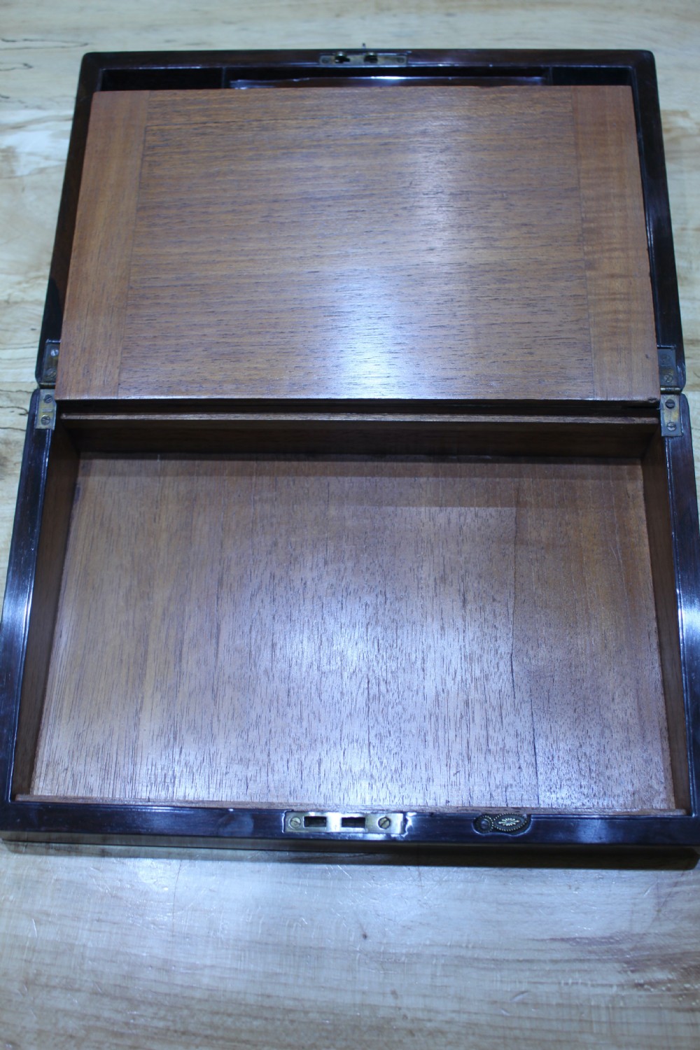 A rectangular dark rosewood writing slope box featuring a central brass cartouche and key inserted in the front lock. View XII