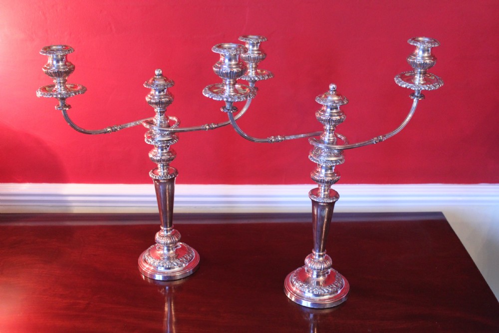 A pair of silver-plated three-light candelabra featuring classical turned column stems, gadrooned borders, and twin curved branches. View II