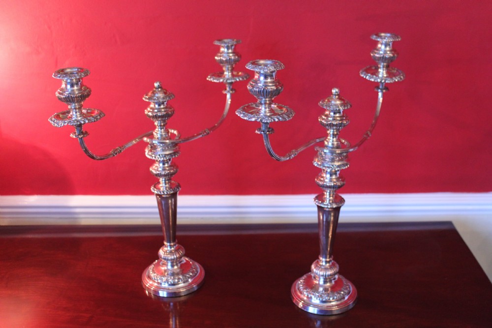 A pair of silver-plated three-light candelabra featuring classical turned column stems, gadrooned borders, and twin curved branches. View III