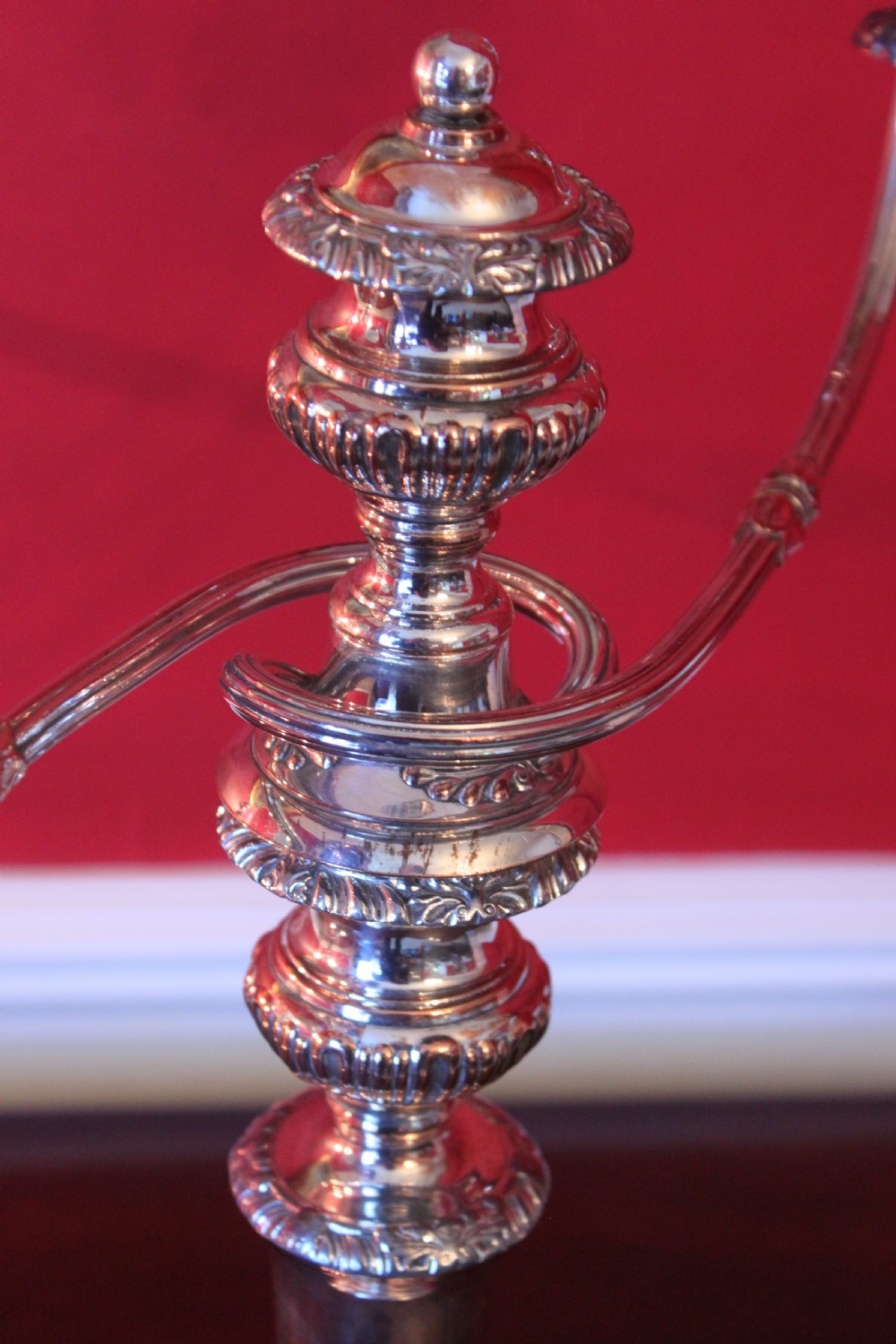 A pair of silver-plated three-light candelabra featuring classical turned column stems, gadrooned borders, and twin curved branches. View VII