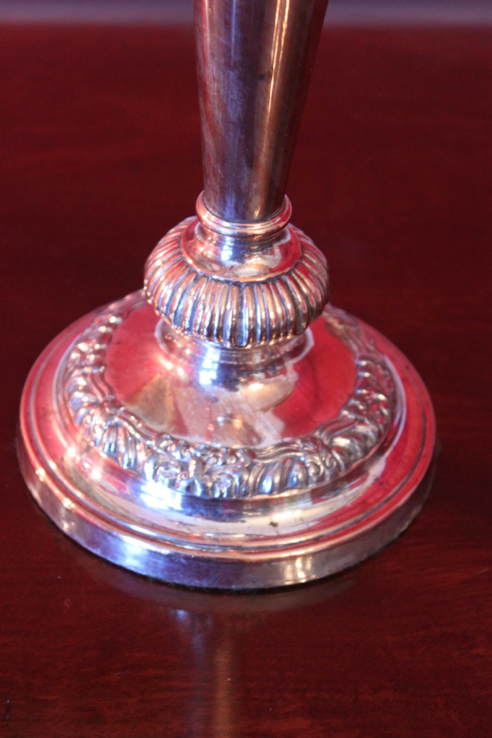 A pair of silver-plated three-light candelabra featuring classical turned column stems, gadrooned borders, and twin curved branches. View IX