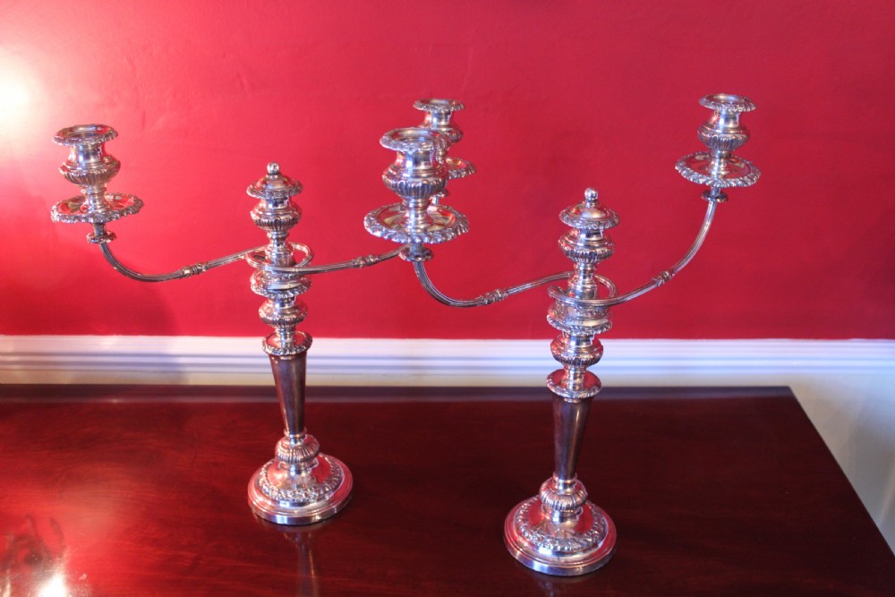 A pair of silver-plated three-light candelabra featuring classical turned column stems, gadrooned borders, and twin curved branches. View XI