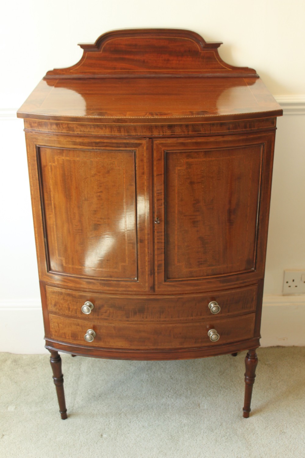 A fine quality Edwardian inlaid bowfront mahogany music cabinet.