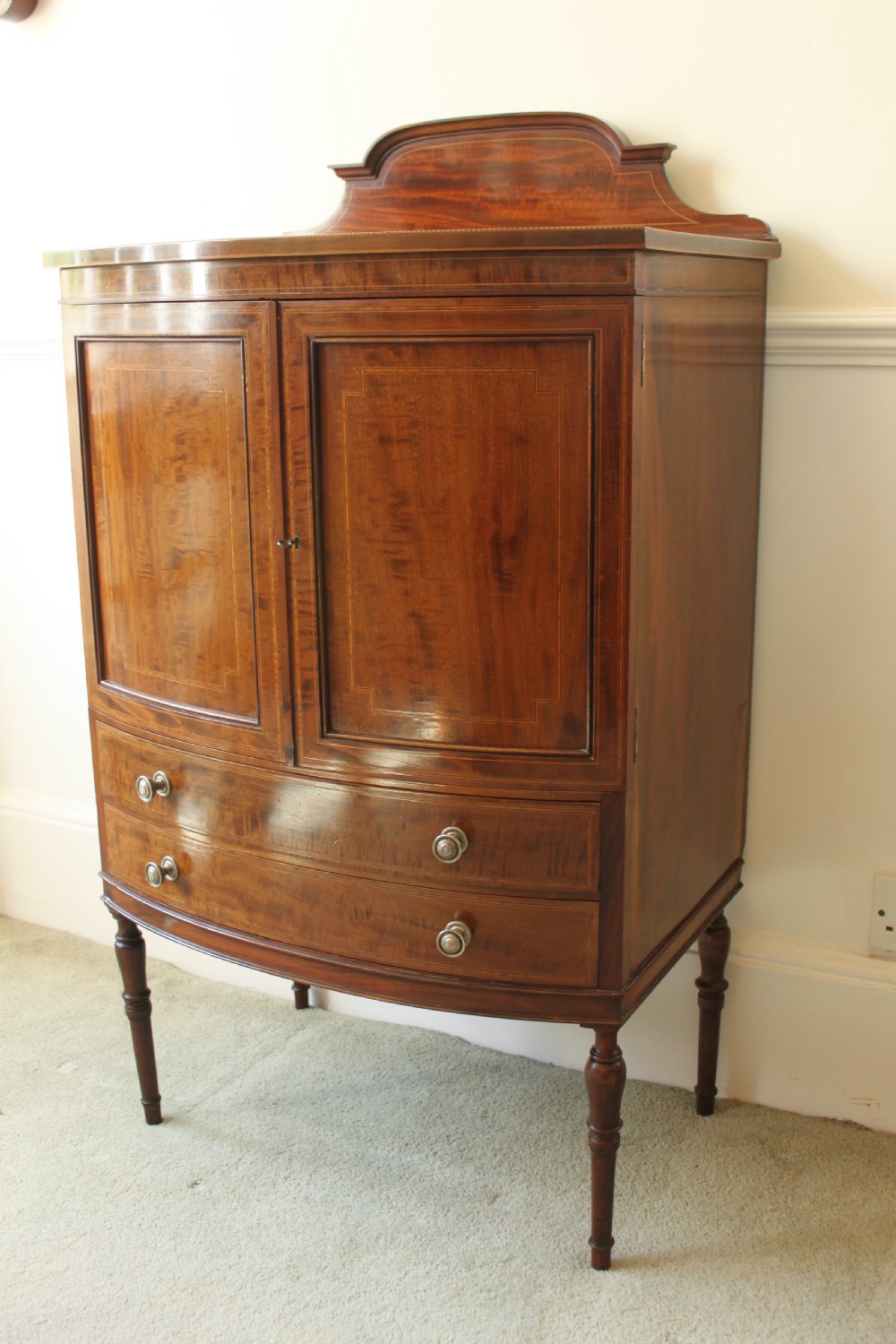 A fine quality Edwardian inlaid bowfront mahogany music cabinet. View II