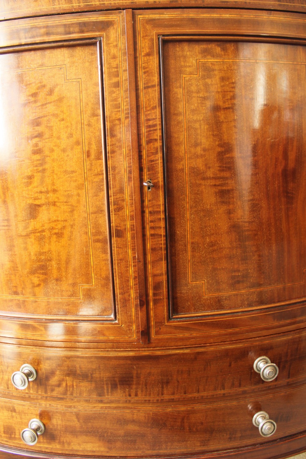 A fine quality Edwardian inlaid bowfront mahogany music cabinet. View VI