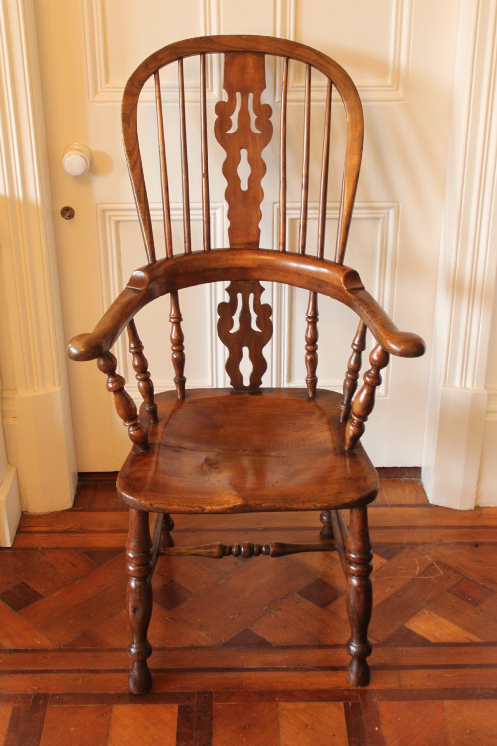 A 19th century north country ash and elm broadarm Windsor armchair.
