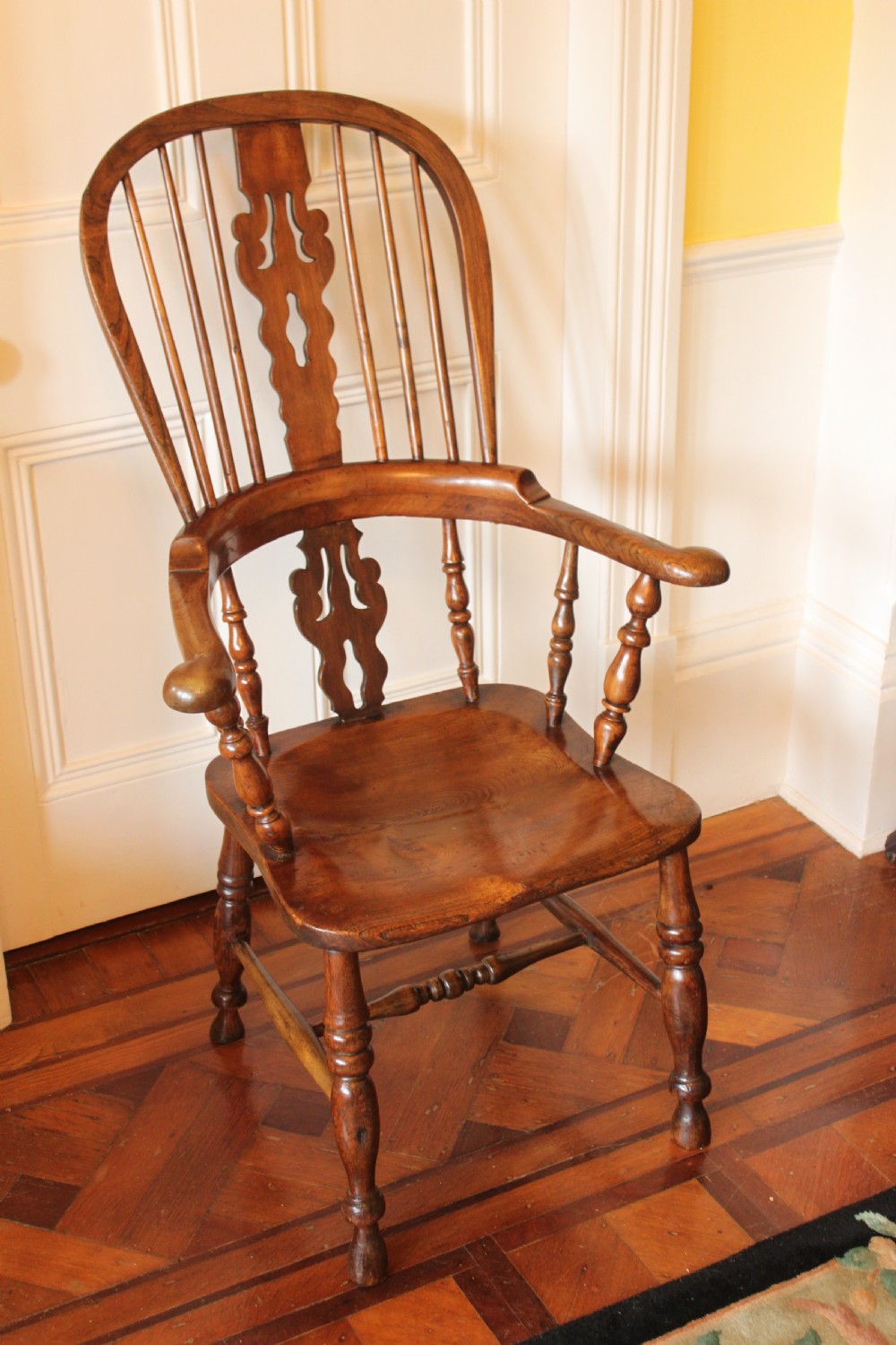 A 19th century north country ash and elm broadarm Windsor armchair. View II