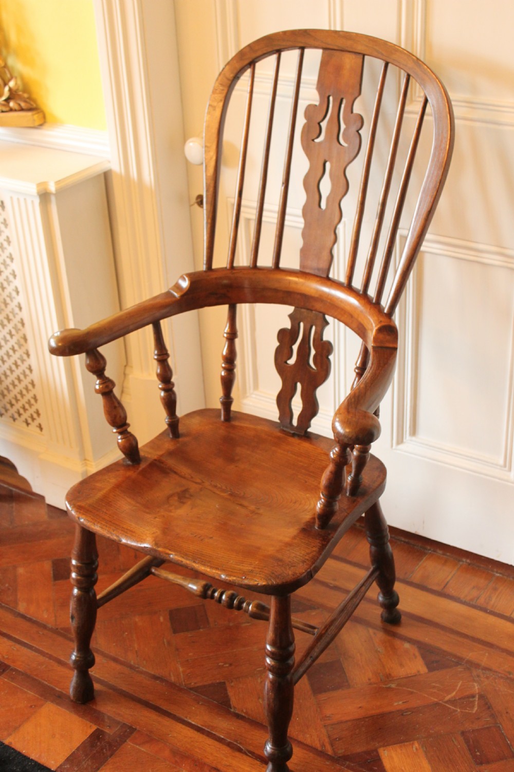 A 19th century north country ash and elm broadarm Windsor armchair. View III