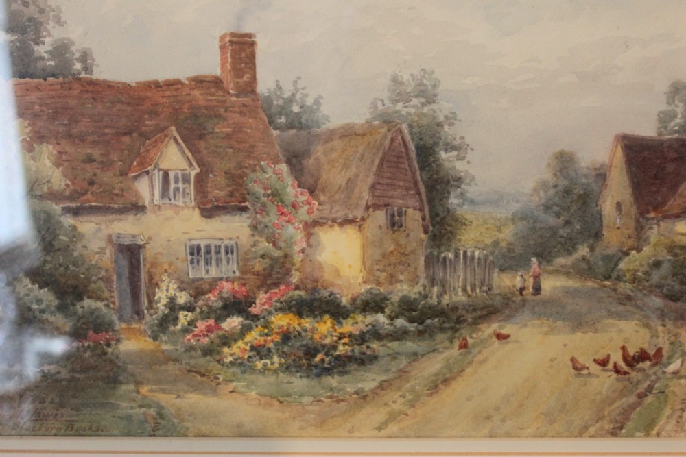 A framed watercolour landscape painting by Harold Lawes depicting a thatched English country cottage along a dirt road with chickens, enclosed in a gilded frame with a cream mount. View II