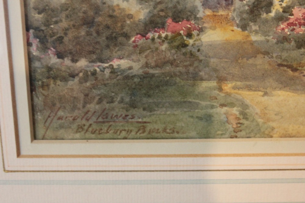 A framed watercolour landscape painting by Harold Lawes depicting a thatched English country cottage along a dirt road with chickens, enclosed in a gilded frame with a cream mount. View III