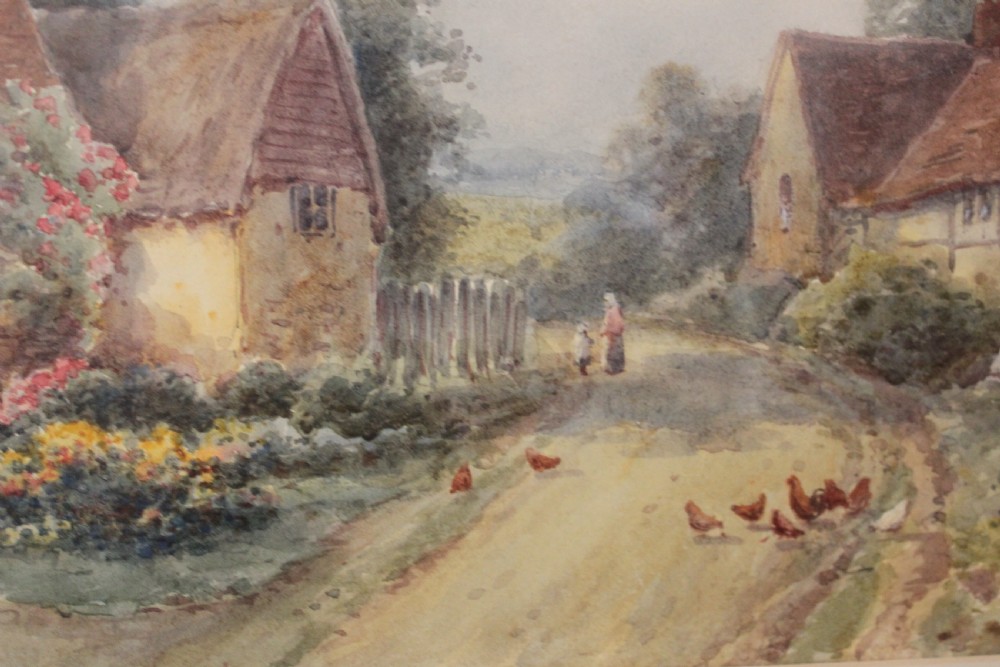 A framed watercolour landscape painting by Harold Lawes depicting a thatched English country cottage along a dirt road with chickens, enclosed in a gilded frame with a cream mount. View IV