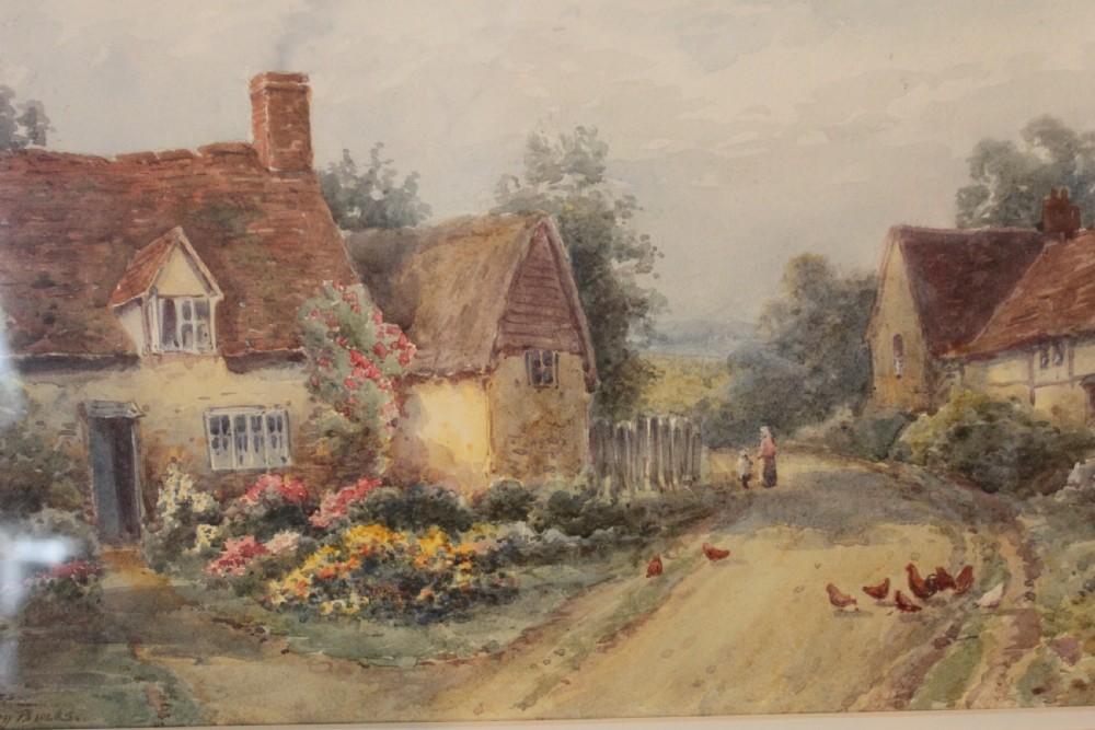 A framed watercolour landscape painting by Harold Lawes depicting a thatched English country cottage along a dirt road with chickens, enclosed in a gilded frame with a cream mount. View VI
