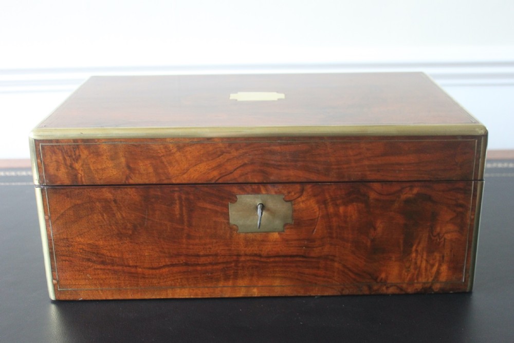 A Victorian figured walnut writing slope with secret drawers.