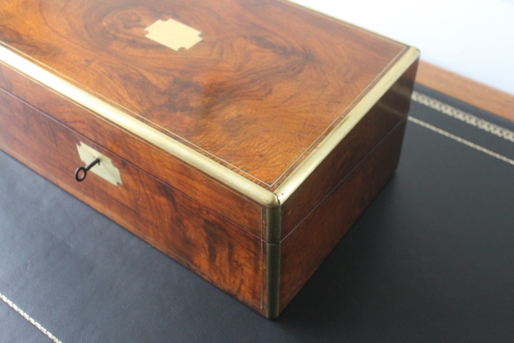 A Victorian figured walnut writing slope with secret drawers. View IV