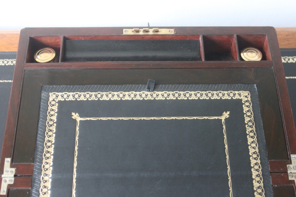 A Victorian figured walnut writing slope with secret drawers. View VIII