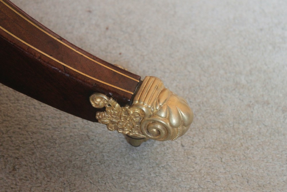 A dark mahogany Regency Pembroke table featuring brass line inlay, a single end drawer, drop leaves, and quadform sabre legs with brass cap castors. View III