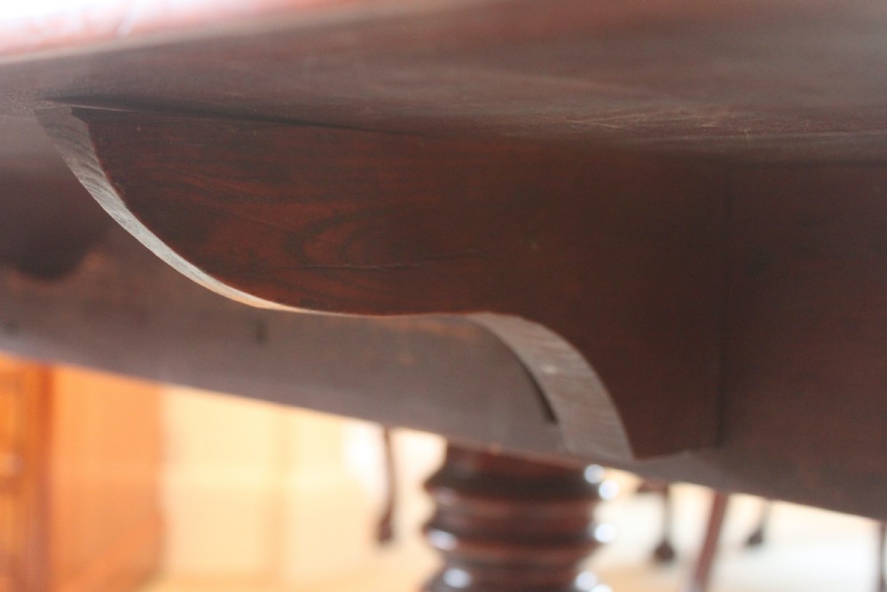 A dark mahogany Regency Pembroke table featuring brass line inlay, a single end drawer, drop leaves, and quadform sabre legs with brass cap castors. View XII