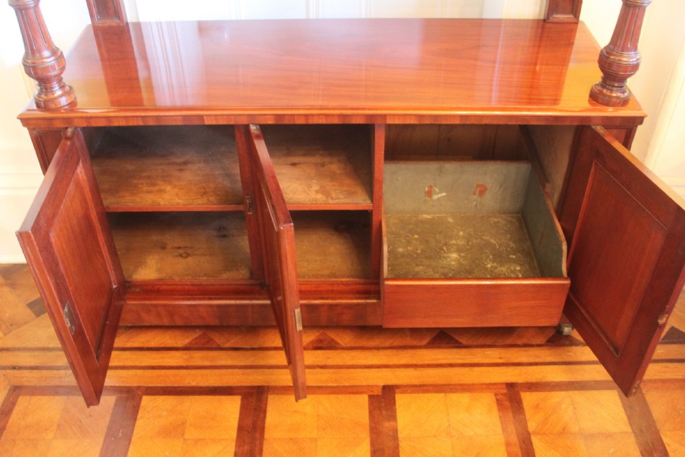 Victorian mahogany buffet sideboard featuring a raised upper tier supported by turned columns above a three-door cupboard base. View VI