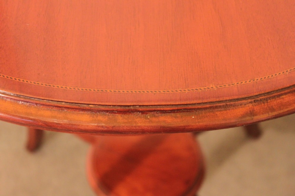 An Edwardian mahogany circular occasional table featuring slender curved legs connected by an X-shaped cross-stretcher with a small circular central under-tier. View VI