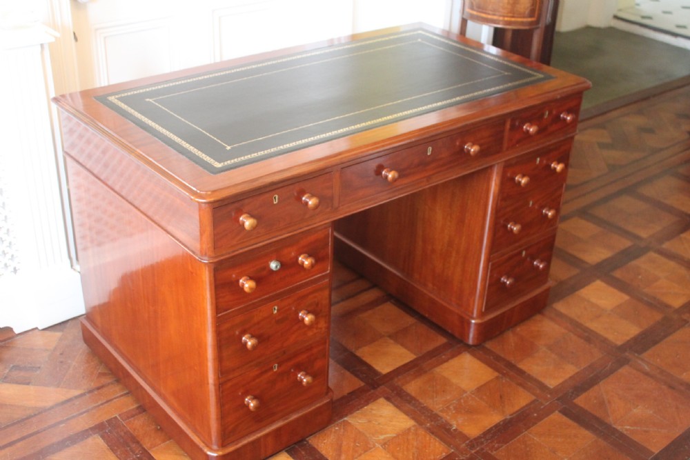 Victorian mahogany pedestal desk with a dark green leather inset top and nine drawers with turned handles. View III