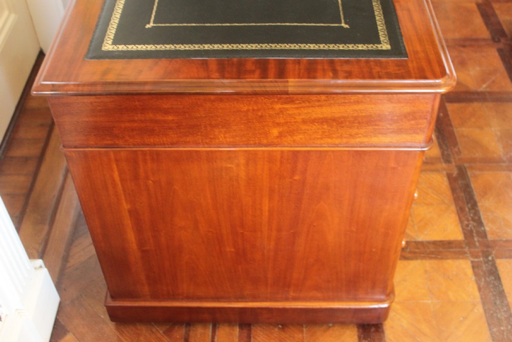 Victorian mahogany pedestal desk with a dark green leather inset top and nine drawers with turned handles. View VII