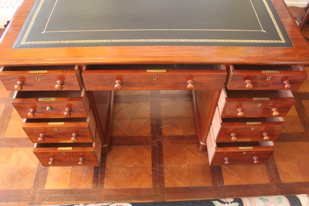 Victorian mahogany pedestal desk with a dark green leather inset top and nine drawers with turned handles. View XIII
