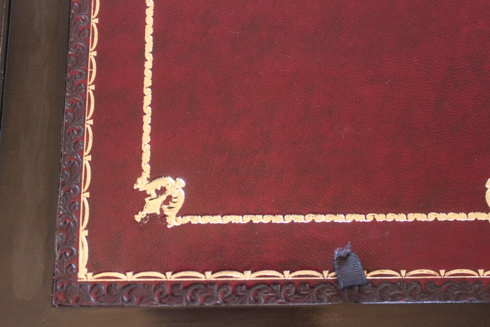 A closed rectangular Victorian burr walnut writing slope decorated with two wide brass straps and a central brass shield inlay. View VII