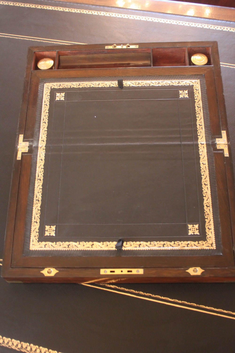 A closed rectangular Victorian writing slope constructed from figured walnut with brass corner mounts and a brass lock escutcheon. View V
