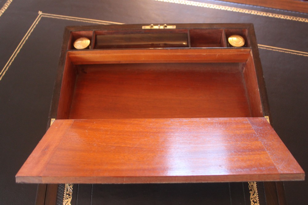 A closed rectangular Victorian writing slope constructed from figured walnut with brass corner mounts and a brass lock escutcheon. View VII
