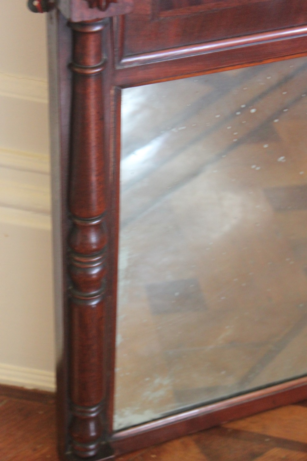 A George IV mahogany pier mirror featuring turned side columns, carved rosettes, a stepped cornice, and an aged glass plate. View III