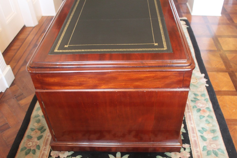 A Victorian mahogany partners desk featuring a dark leather writing insert, multiple pedestal drawers with turned wooden knobs, and a central frieze drawer. View VIII