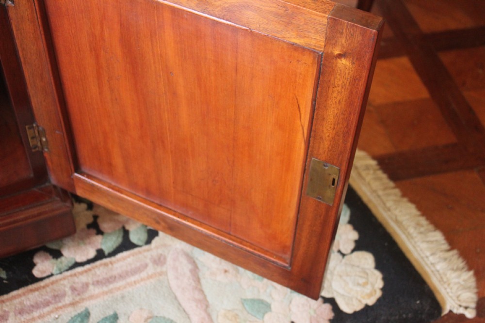 A Victorian mahogany partners desk featuring a dark leather writing insert, multiple pedestal drawers with turned wooden knobs, and a central frieze drawer. View XIV
