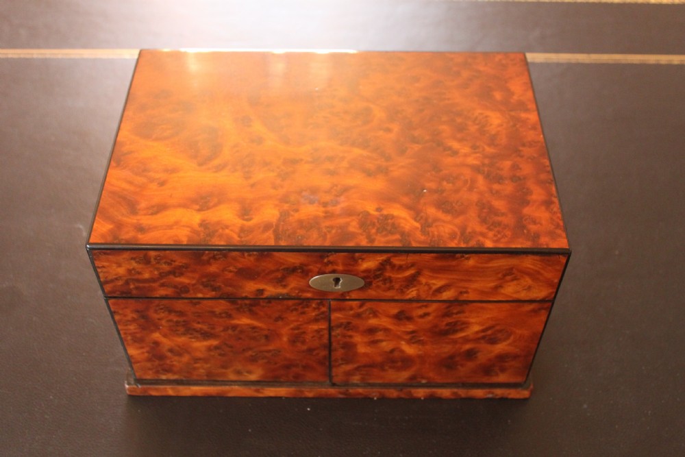 An opened Victorian burr walnut games compendium displaying wooden chess pieces, draughts, cribbage board, and an inlaid game board attached inside the lid. View VIII