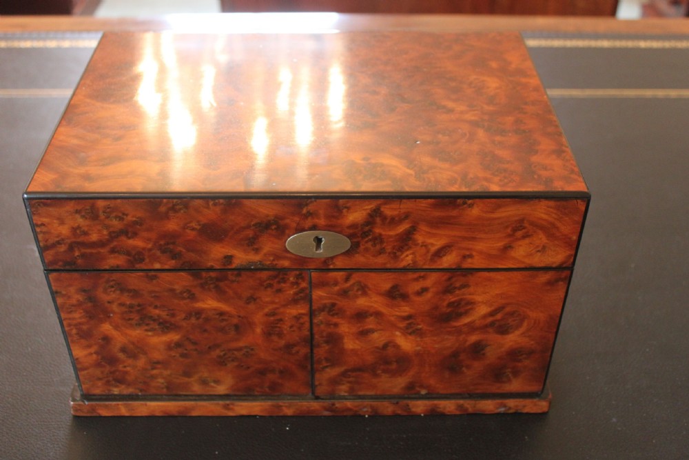 An opened Victorian burr walnut games compendium displaying wooden chess pieces, draughts, cribbage board, and an inlaid game board attached inside the lid. View IX