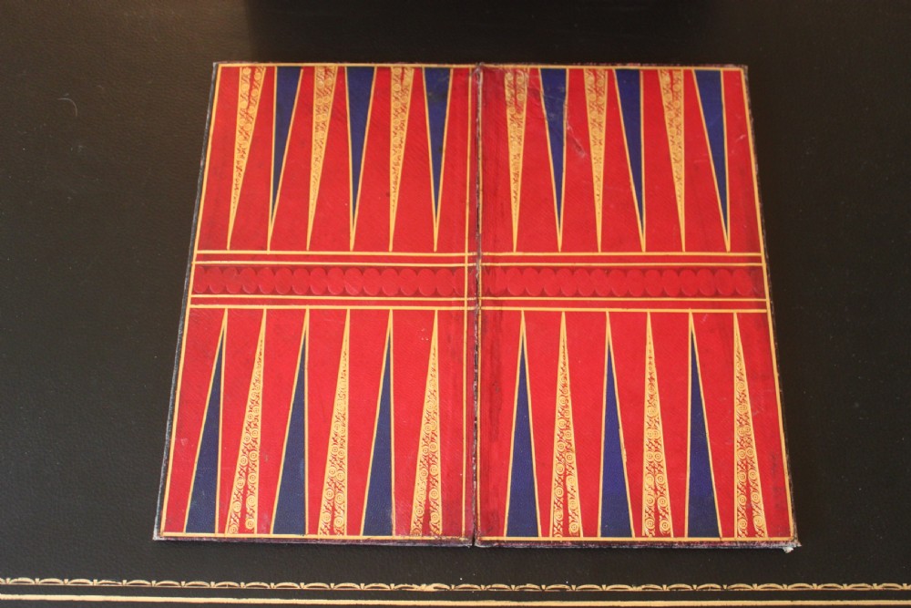 An opened Victorian burr walnut games compendium displaying wooden chess pieces, draughts, cribbage board, and an inlaid game board attached inside the lid. View XV
