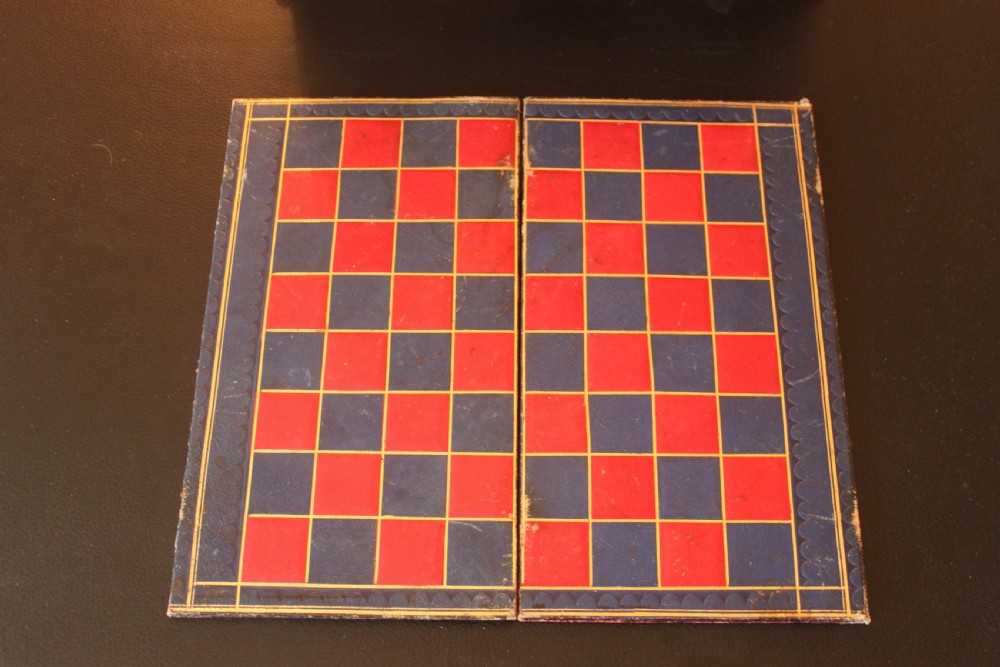 An opened Victorian burr walnut games compendium displaying wooden chess pieces, draughts, cribbage board, and an inlaid game board attached inside the lid. View XVI