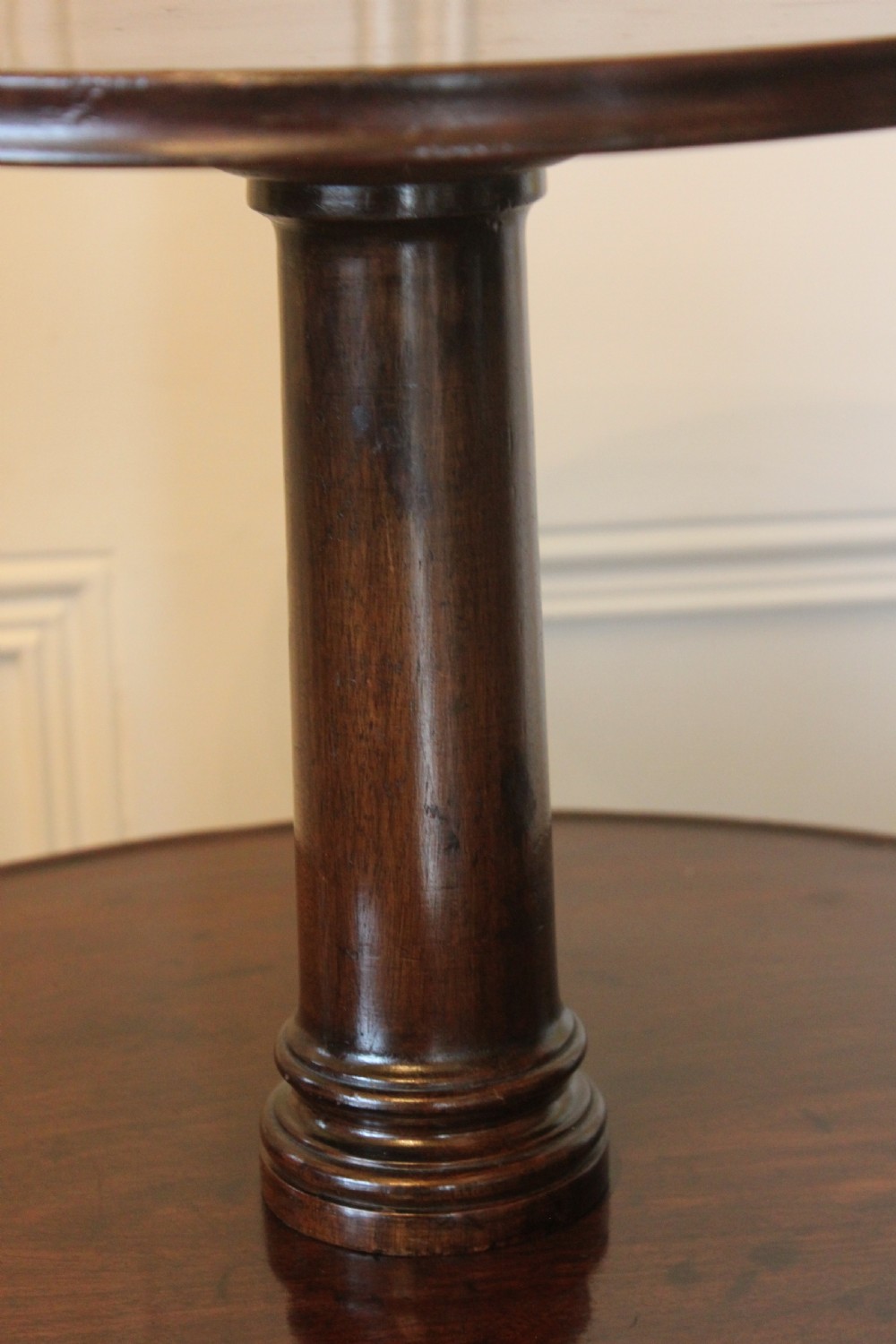 A three-tier Georgian mahogany dumb waiter featuring graduated revolving circular surfaces on a turned central column with a tripod base. View VI