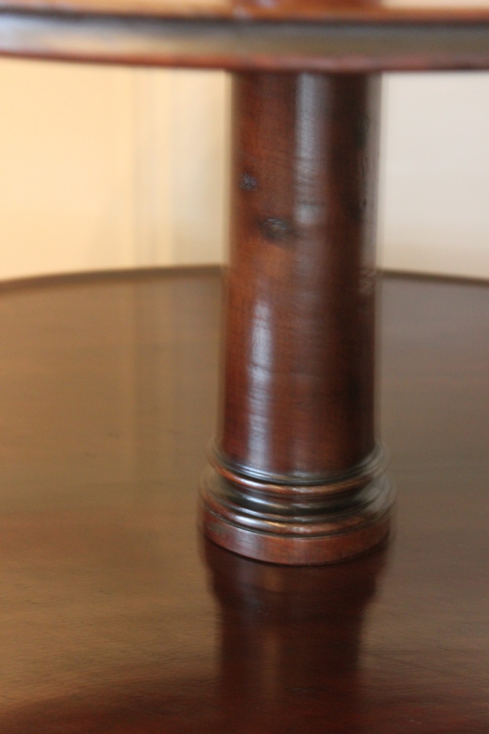 A three-tier Georgian mahogany dumb waiter featuring graduated revolving circular surfaces on a turned central column with a tripod base. View VII