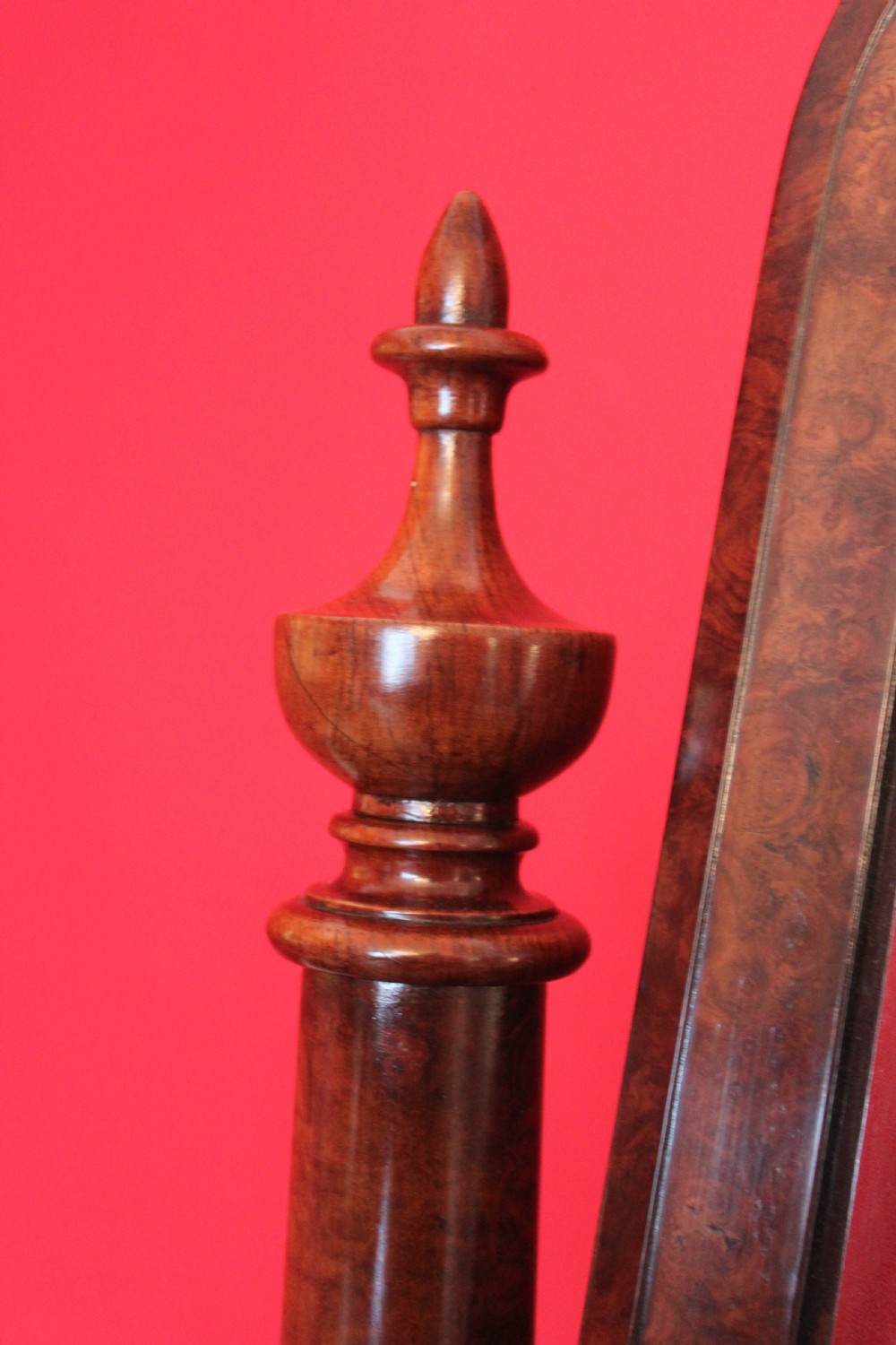 A Victorian burr walnut toilet mirror featuring a tilting arched glass frame set between turned columns with extended brass candle sconces on a shaped plinth base. View VIII